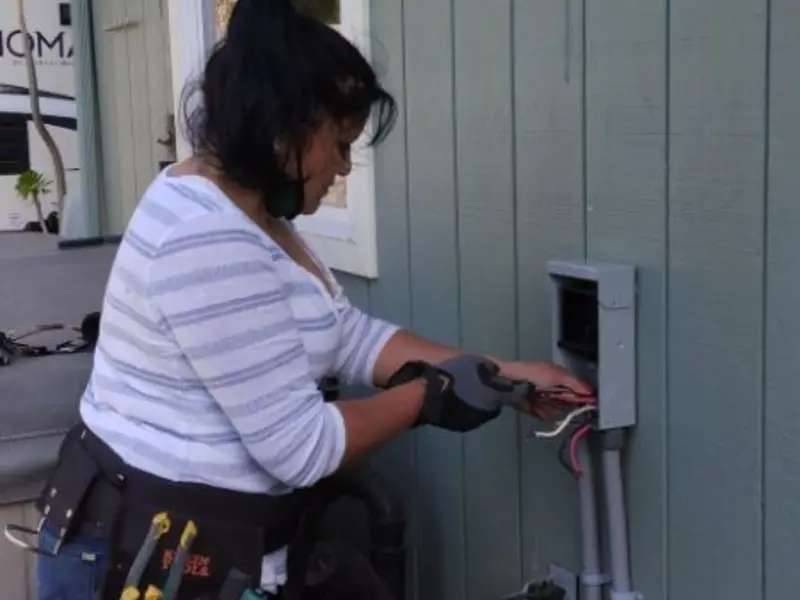 Licensed electrician wiring an exterior subpanel in Cedar Mill